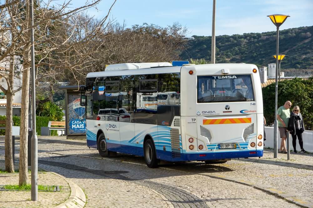Local bus stopping on a traditional avenue near the village centre of Praia da Luz