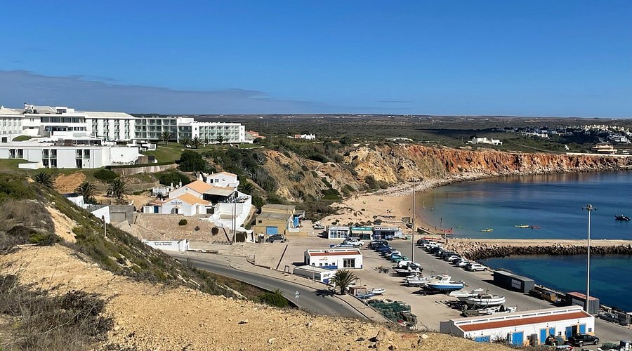 Traditional and modern fishing vessels docked safely at the active working harbour of Porto da Baleeira in Sagres