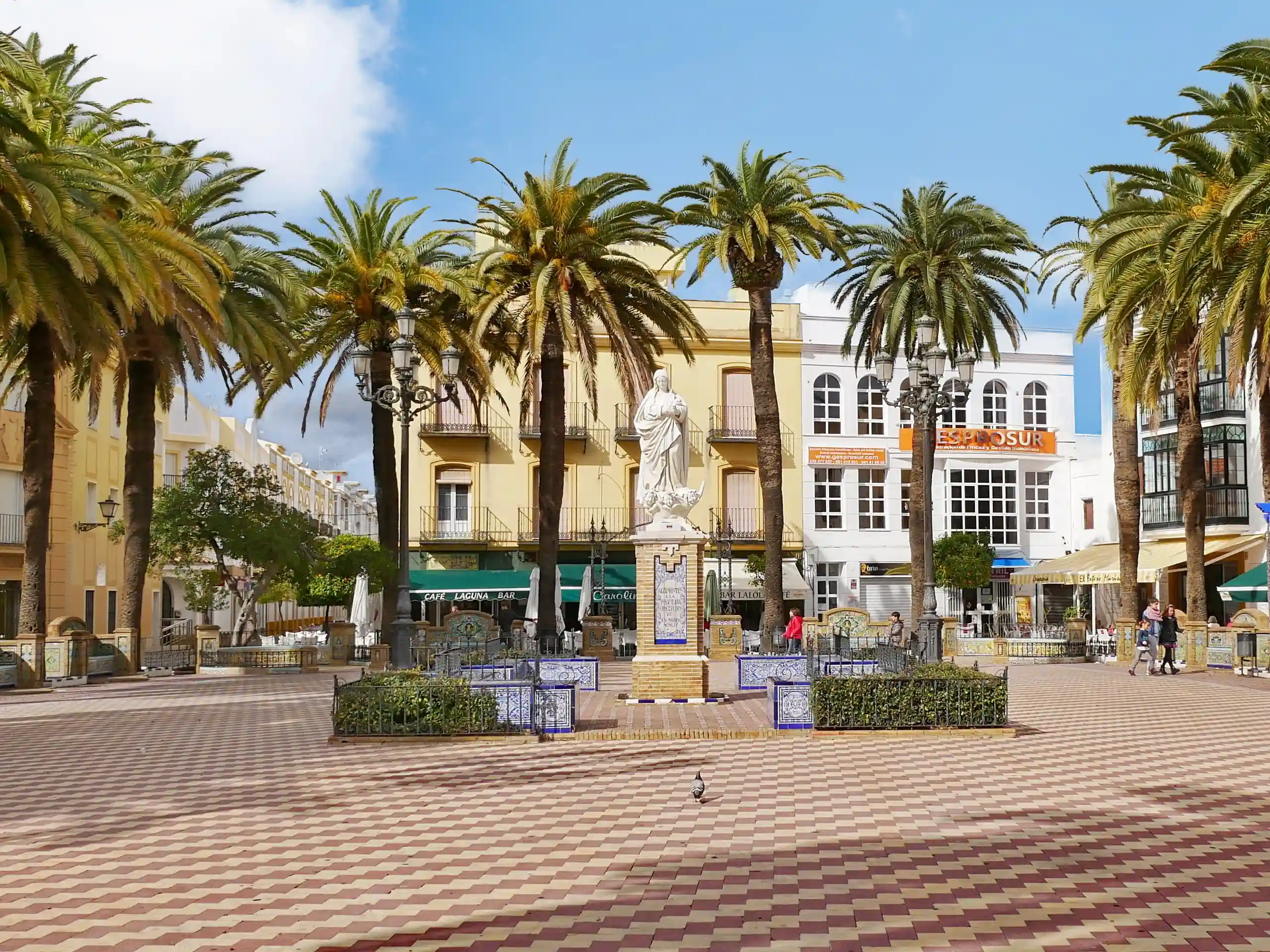 The colourful waterfront buildings and palm trees of Ayamonte, Spain, easily reached via the international ferry connection