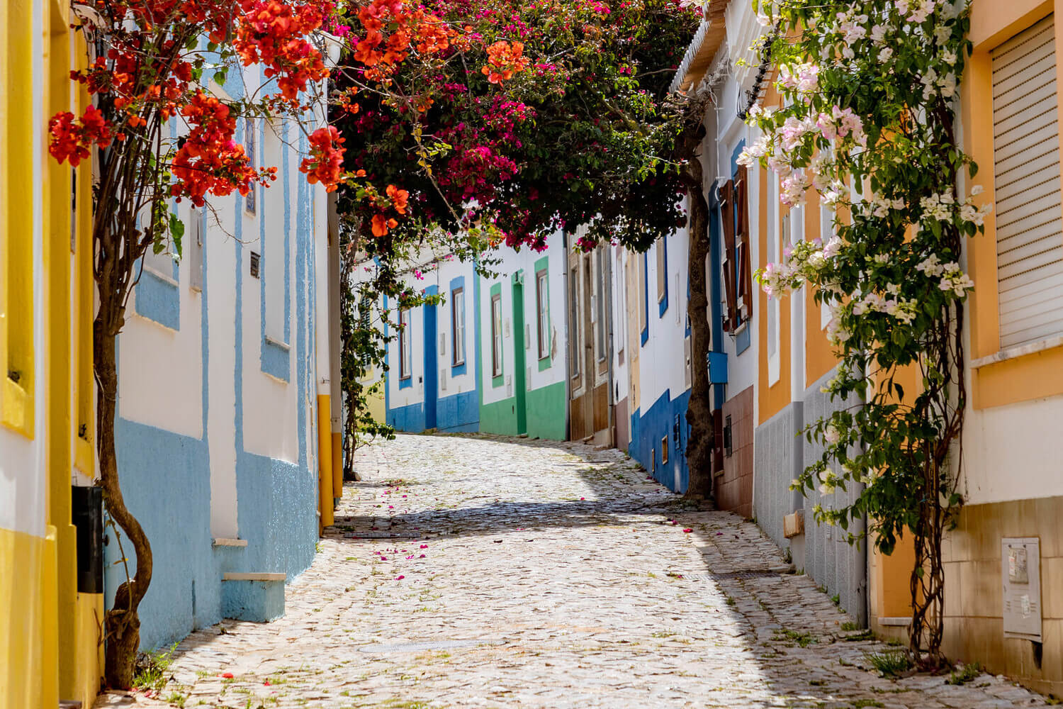 Traditional whitewashed houses and narrow stone cobbled streets in the nearby fishing village of Ferragudo