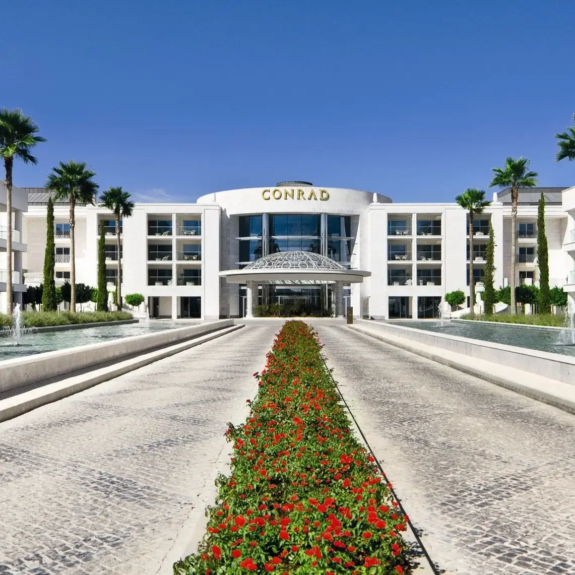 Modern palm-lined entrance at the 5-star Conrad Algarve hotel in Quinta do Lago
