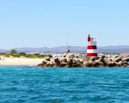 A local Portuguese fisherman working with traditional equipment along the tidal lagoon waters in Cabanas