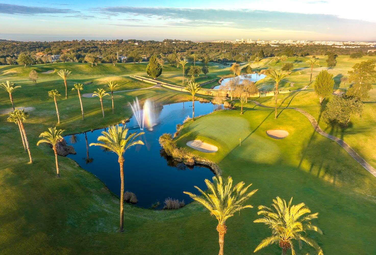 Perfectly manicured green fairways and surrounding olive trees at the premium Gramacho Golf Course near Lagoa