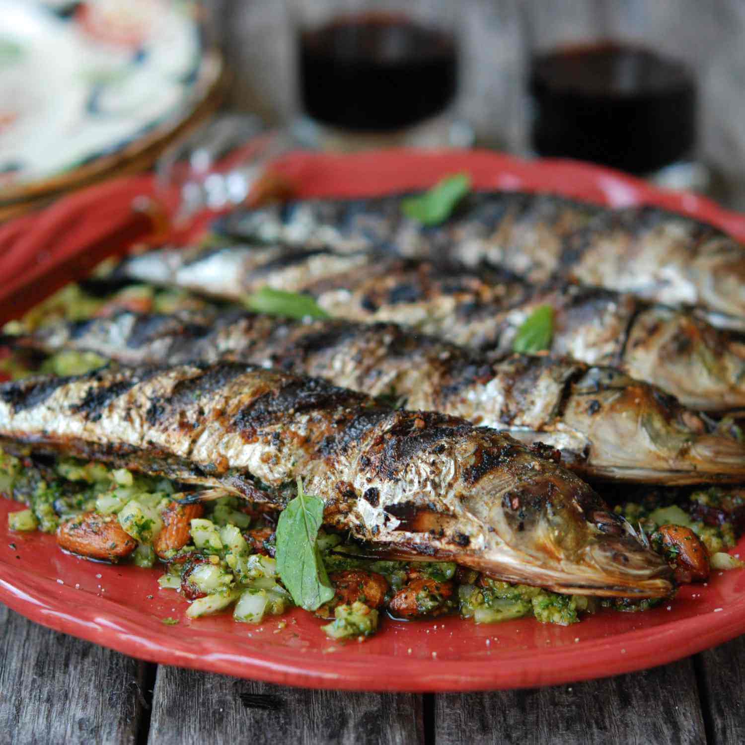 A hot grill loaded with traditional fresh sea sardines cooking outdoors at the famous Portimão culinary festival