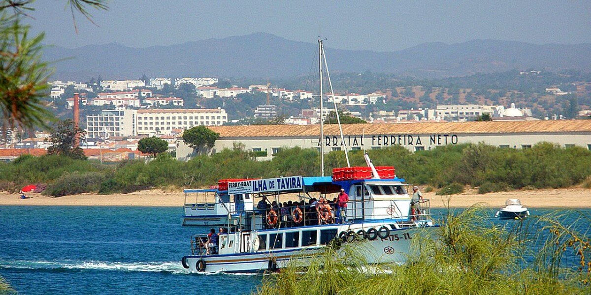 Small passenger ferry boat at the pier waiting to transport visitors across to Cabanas Island beach