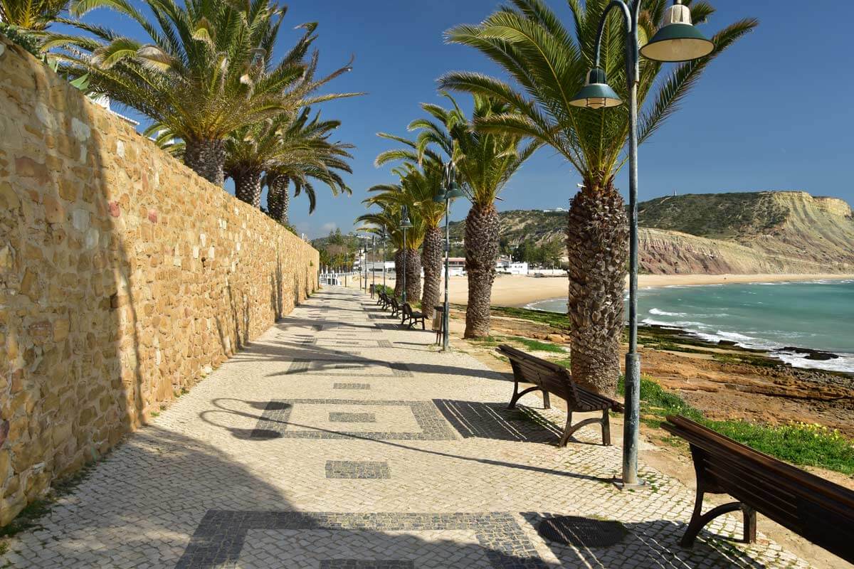Vibrant commercial promenade and beachfront cafes in Praia da Luz Town Centre
