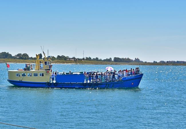 A vehicle and passenger transport ferry navigating across the scenic Guadiana River connecting Portugal and Spain