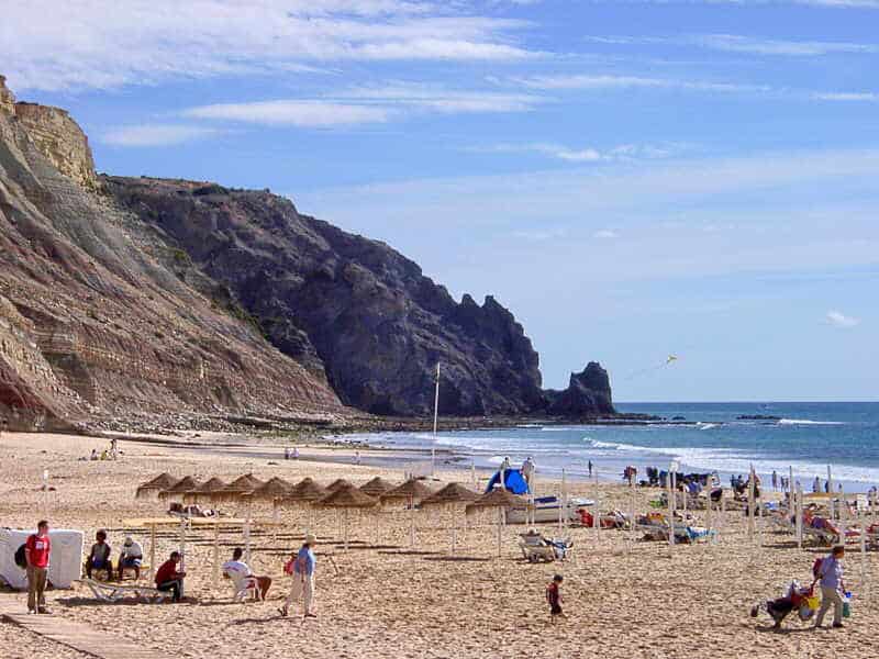 The iconic dark volcanic rock formations of the Rocha Negra cliff face towering over Luz