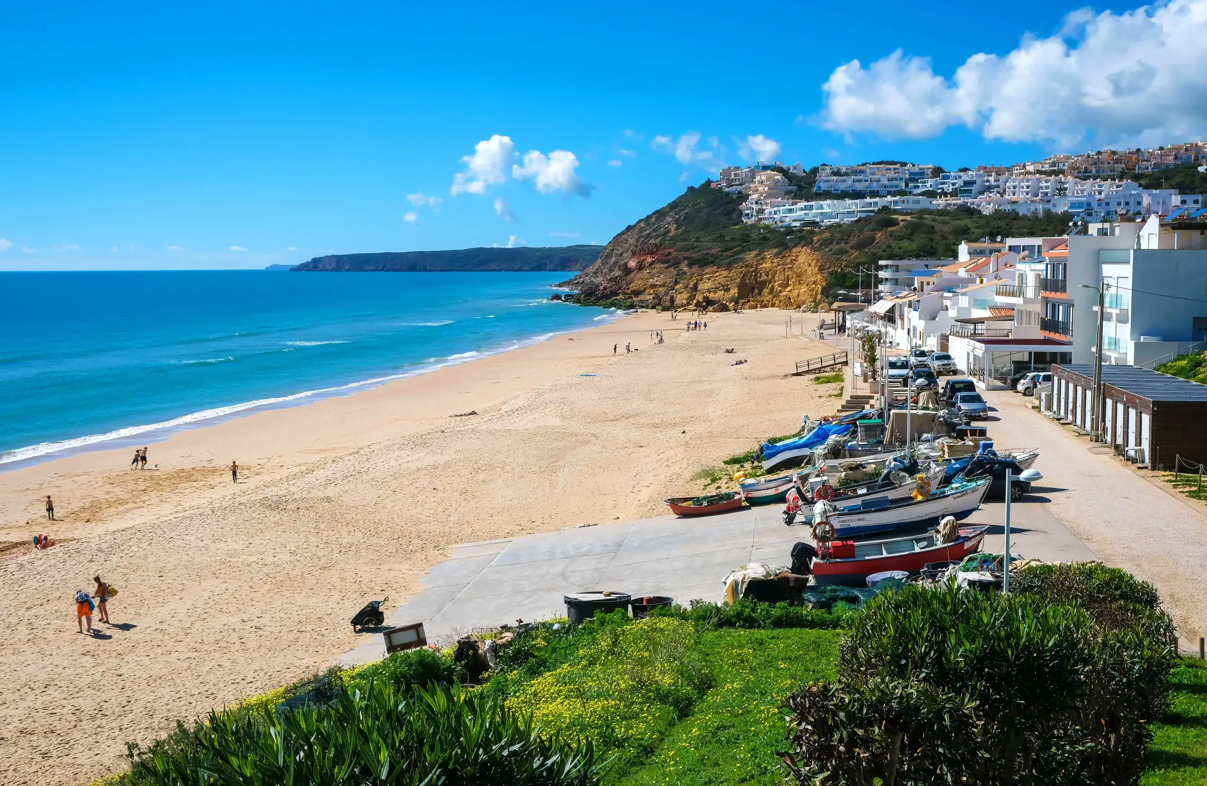 Scenic panoramic view of Salema beach in the western Algarve, featuring the traditional fishing village front and golden sands