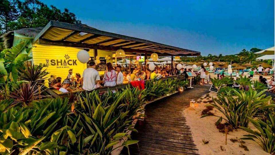 Relaxed wooden lakeside terrace setting at The Shack Bar overlooking the calm resort lake