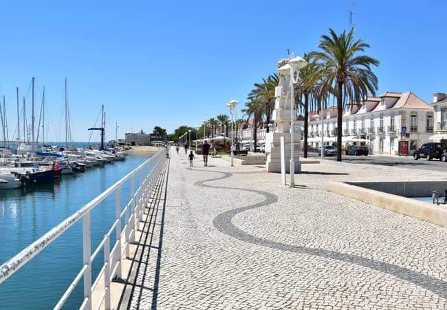 The tranquil pedestrian promenade flanking the wide Guadiana river mouth along the border edge of Vila Real de Santo António