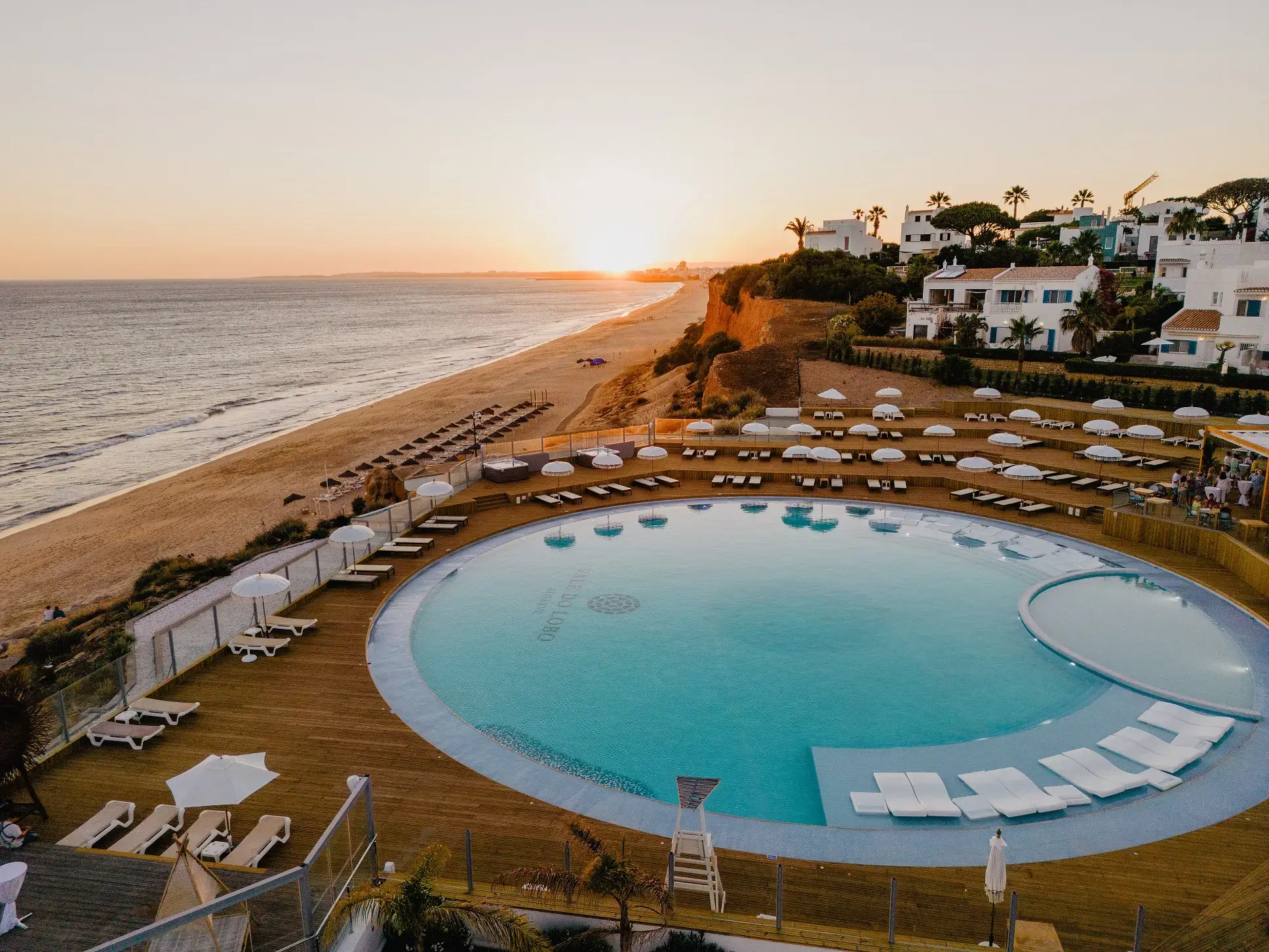 The stylish outdoor pool, beachside lounge deck, and ocean view terrace at Well Restaurant in Vale do Lobo